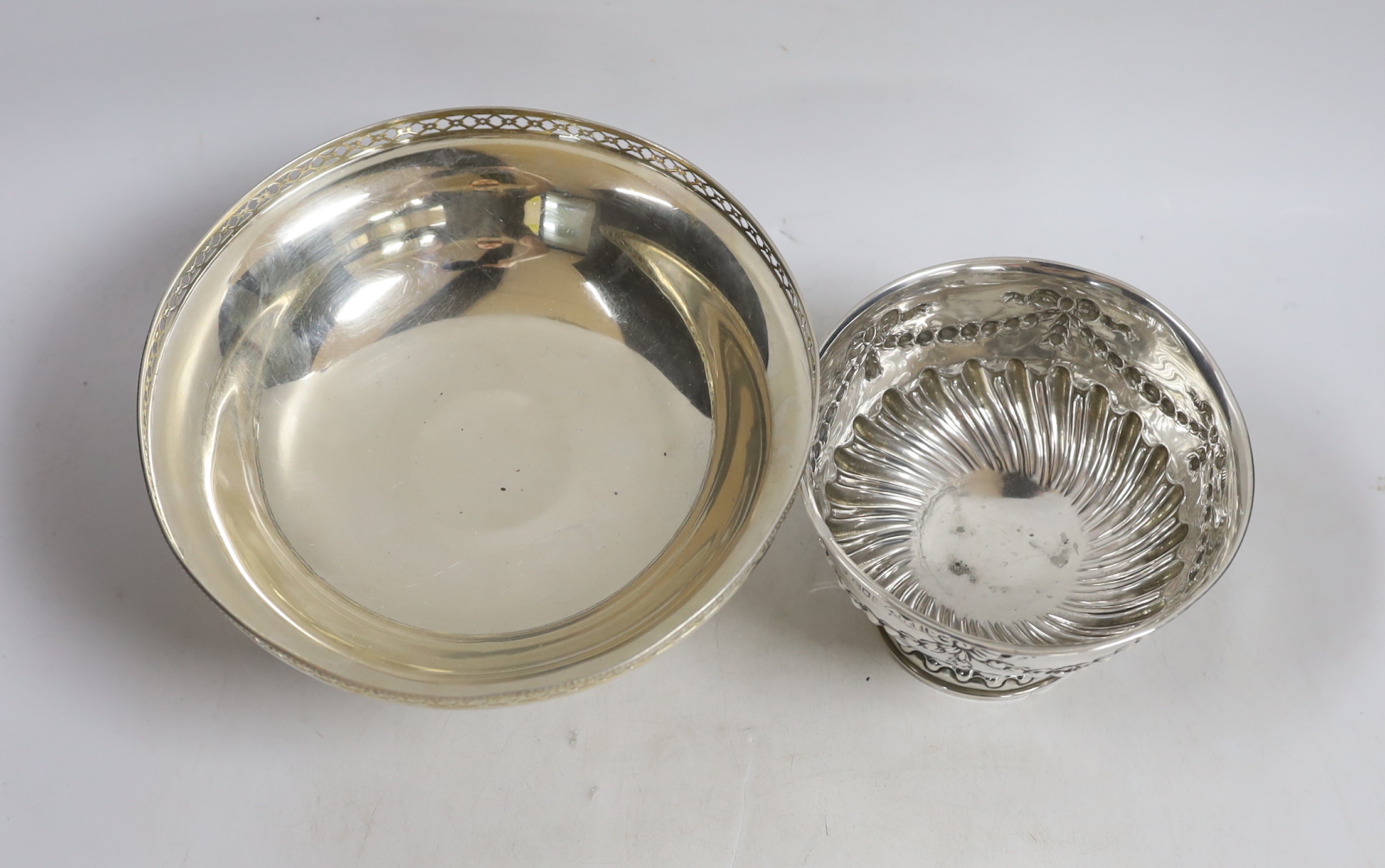 An Edwardian small repousse silver rose bowl, Charles Stuart Harris & Sons London, 1904, diameter 13.7cm and a later larger silver pedestal bowl, 15.3oz.